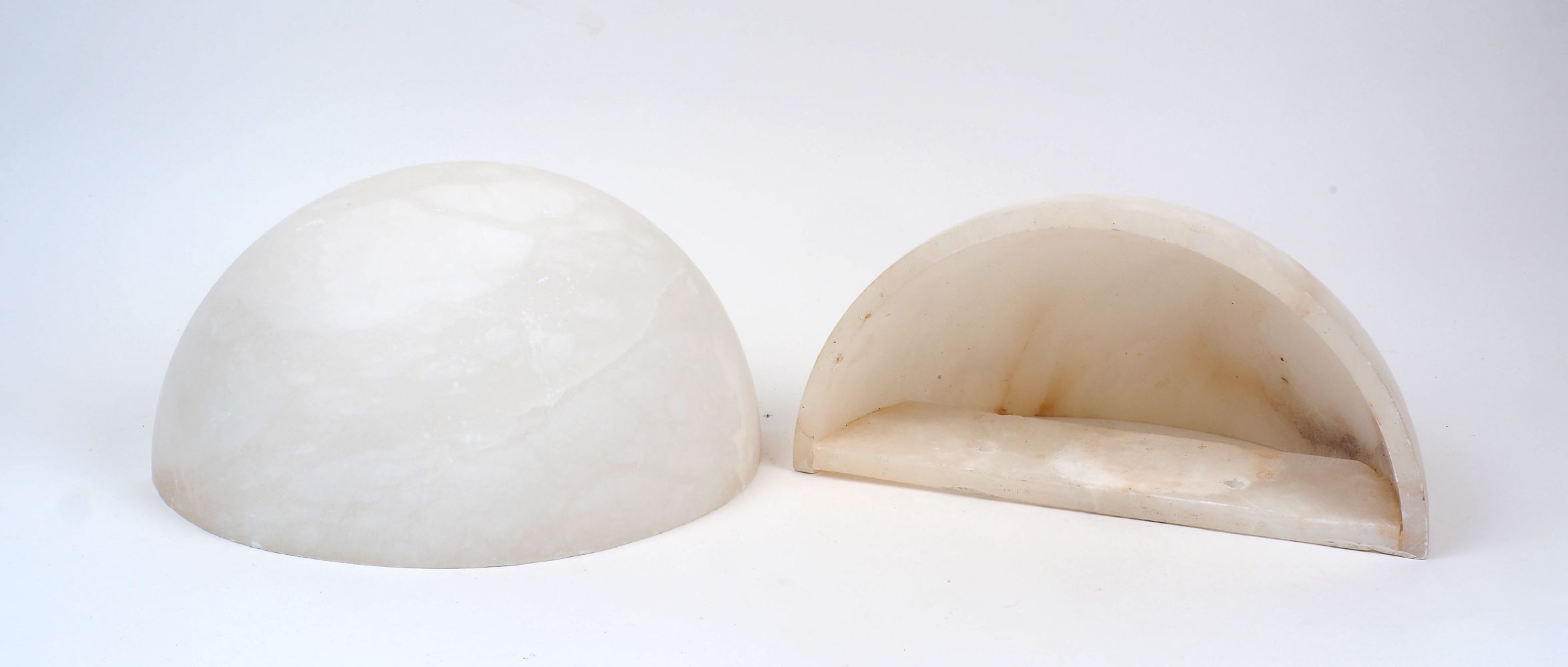 A pair of alabaster wall uplighter shades, 20th Century, of quarter spherical form with hollowed