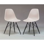 Charles and Ray Eames, a pair of Vitra Eames plastic chairs, in grey, made in Germany, raised on