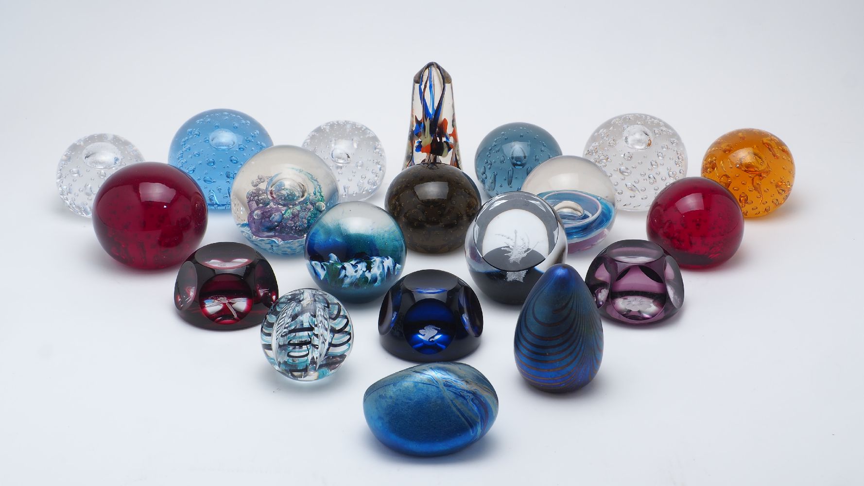 A collection of twenty glass paperweights, various makers; comprising: three Webb Corbett examples -