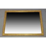 A large 20th Century gilt frame with a single smoky glass pane, creating a mirrored effect,