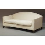 A pair of contemporary cream upholstered two-seater settees, of recent manufacture, arched backs and