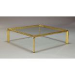 A late 20th Century brass framed and glass inset coffee table, circa 1970s, measuring 33cm high,