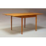 A Danish teak veneered extending draw-leaf dining table, by A Mobler, bearing a label to