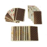 A deck of playing cards, 20th century, in faux-ivory, possibly celluloid, each hand-painted with