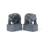 Two hand carved soap stone elephants, 20th Century, each modelled standing on plinth base with