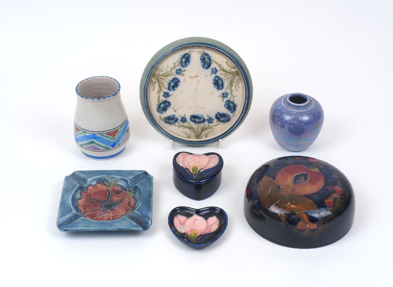 A group of modern decorative pottery, comprising a Moorcroft ash tray, 12cm x 12cm, a Moorcroft