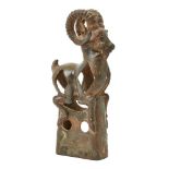 A Western Asiatic openwork bronze finial in the form of a mountain goat with with long curved horns,