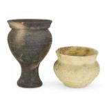 A grey ware pottery vessel with globular body, wide everted rim, set on an integral pedestal base,