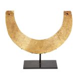 A gold torque necklace in the ancient style, mounted on stand, 17.5cm. diam., 24 grams Provenance: