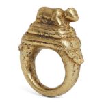 A brass ring with recumbent cow, India, 18th century or earlier, the bezel with a cow lying on a