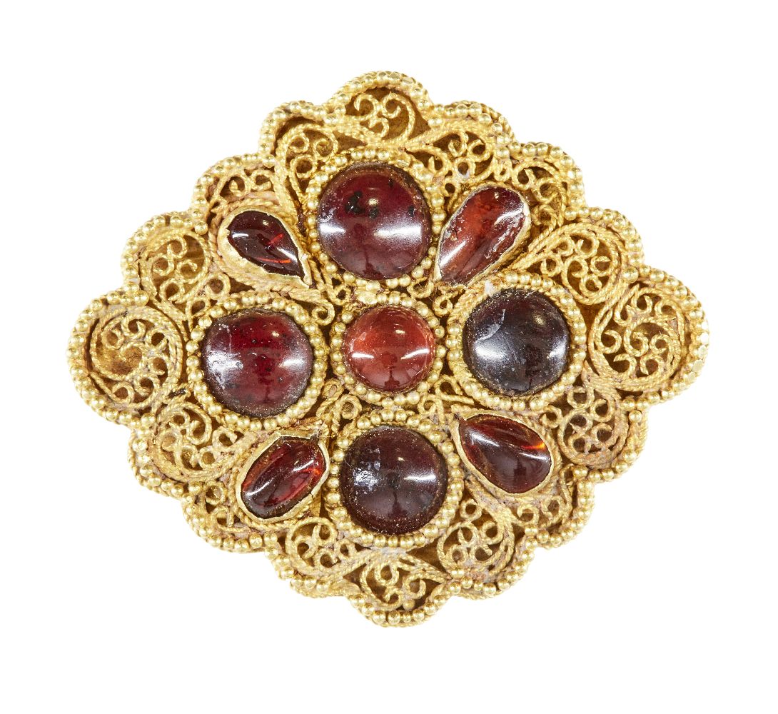 A garnet set gold element, Iran, 12th-13th century, of lobed diamond- form, with four round stones