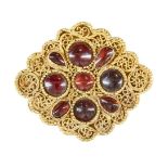 A garnet set gold element, Iran, 12th-13th century, of lobed diamond- form, with four round stones