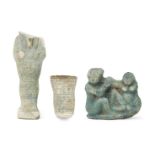 A fragmentary Egyptian blue glazed composition shabti of typical mumiform, holding two hoes, with