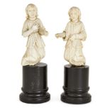 Two carved ivory angels, Goa, India, 19th century, mounted on circular plinths, each with one hand