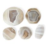 A group of six agate beads, possibly from a necklace, each drilled through centre, largest 5.2cm.