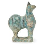 A Kashan turquoise glazed pottery model of a sheep, Iran, 12th century, rising from a rectangular