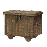 A large Indian iron and wood merchant's coffer, early 20th century, 54cm. high x 79cm. diam. x 51cm.