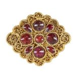 A garnet set gold element, Iran, 12th-13th century, of lobed diamond- form, with four round stones