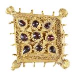 A garnet-set gold pendant element, Iran, 12th century, of diamond shape and box construction, the