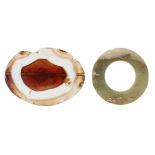A polished agate cross-section and a jade ring, 8.7cm and 6.2cm. diam. (2) Provenance: Private