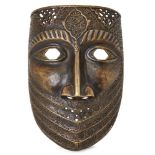 A metalwork mask in Timurid style, 20th century, with openings for the eyes and nostrils,