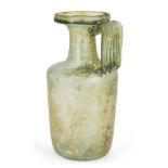 A Roman green glass flask, 1st-3rd century AD, on an indented base, rounded sides and ribbed handle,