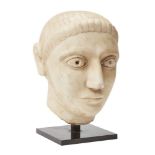 A South Arabian-style carved marble head of a youth, on metal mount, head 23cm. high Provenance: