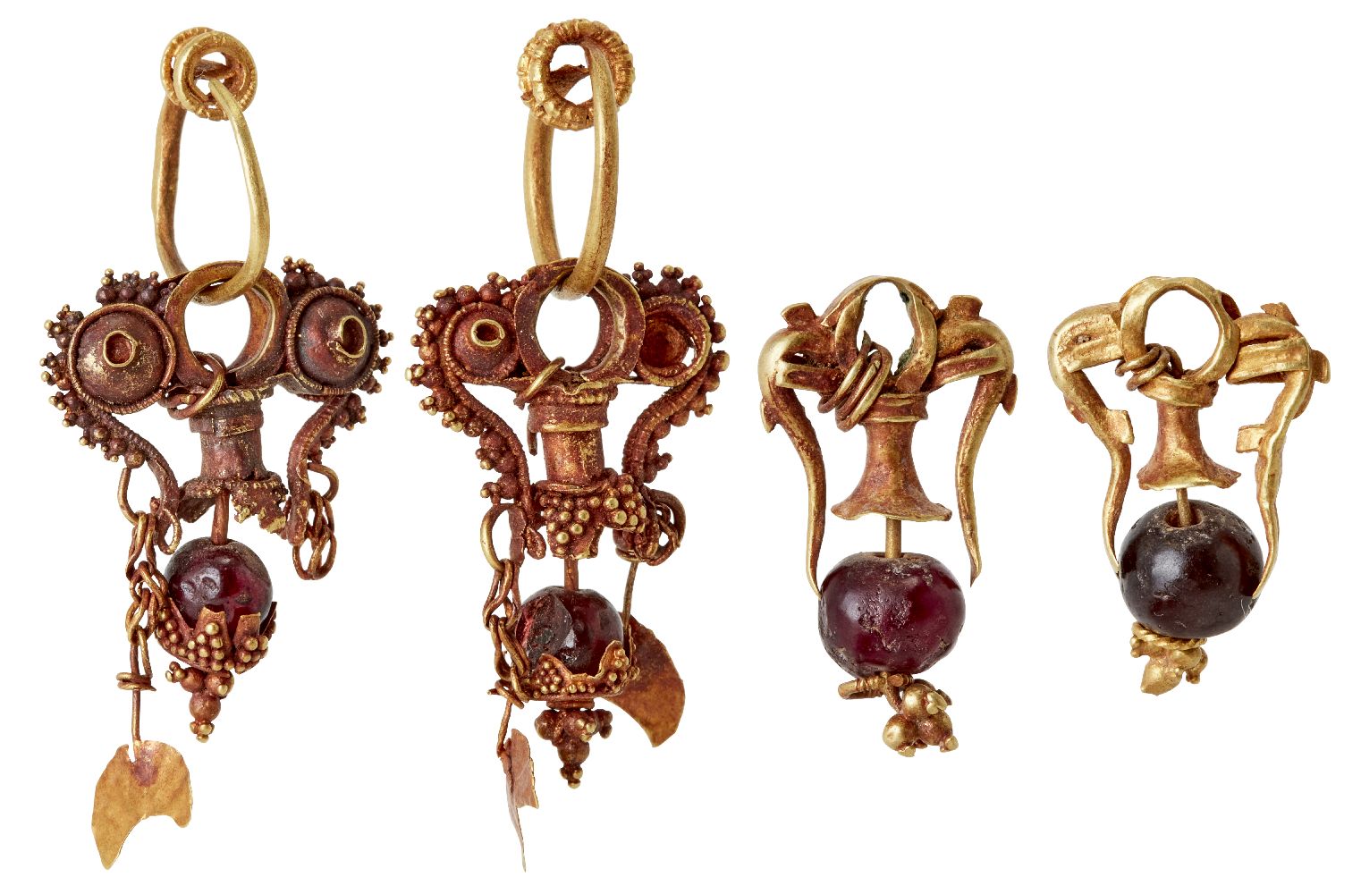 Two pairs of garnet set gold earrings in the ancient style, the first formed of three gold loops,