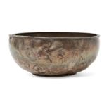 A silver bowl, possibly Sasanian, of deep form with flat base and rounded sides, 12.2cm. diam. x 4.