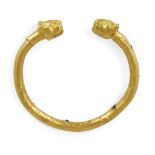 A Parthian gold sheet bracelet with lion head terminals,1st century AD, the gold wrapped