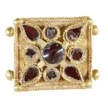 A garnet set gold element, Iran, 12th-13th century, of square form, the central stone with a