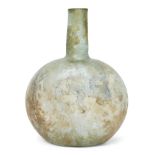 A Roman green glass vessel of spherical form the sides slightly flattened, with cylindrical neck and