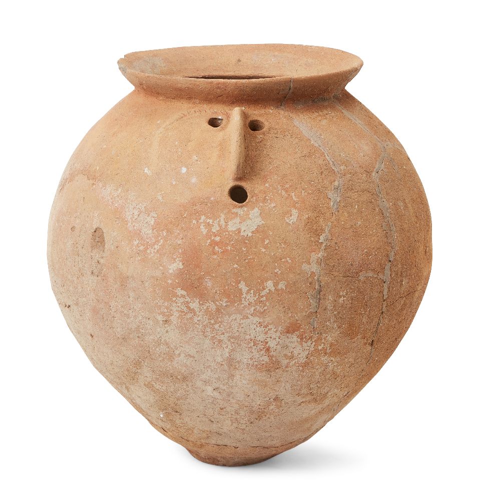 A Roman pottery globular face-urn with everted rim, one side of the body with prominent beak-like