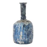 A ribbed cobalt blue glass bottle, Iran, 11th century, with flat bottom, the body with a series of