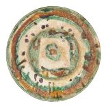 A Nishapur sgraffito splashware pottery dish, Iran, 10th century, the earthenware body incised to