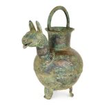 A large inscribed bronze tripod ewer in the form of a camel, Northeast Iran, 12th century, on