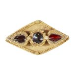 A garnet set gold element, Iran, 12th-13th century, of diamond-form, the central round stone with