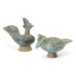 Two Kashan blue and black glazed pottery models of birds, Iran, 12th century. both on a raised foot,