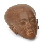 An Egyptian style brown quartzite head of an Amarna style princess, with elongated skull and defined