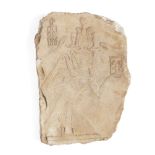 An Egyptian style limestone relief fragment of a kneeling pharaoh wearing a kilt, and an atef crown,