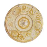 A Hispano-Moresque pottery dish, Spain, 17th century, the centre with raised well, the cavetto