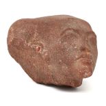 An Egyptian style red sandstone head of an Amarna style princess, with elongated skull with the