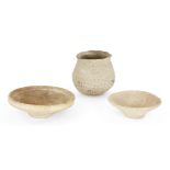 Three Mesopotamian buff coloured coarse ware pottery vessels, including two dishes, one with