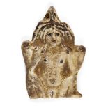 An ancient Egyptian white faience amulet of the Greco-Egyptian goddess Baubo, circa 1st century