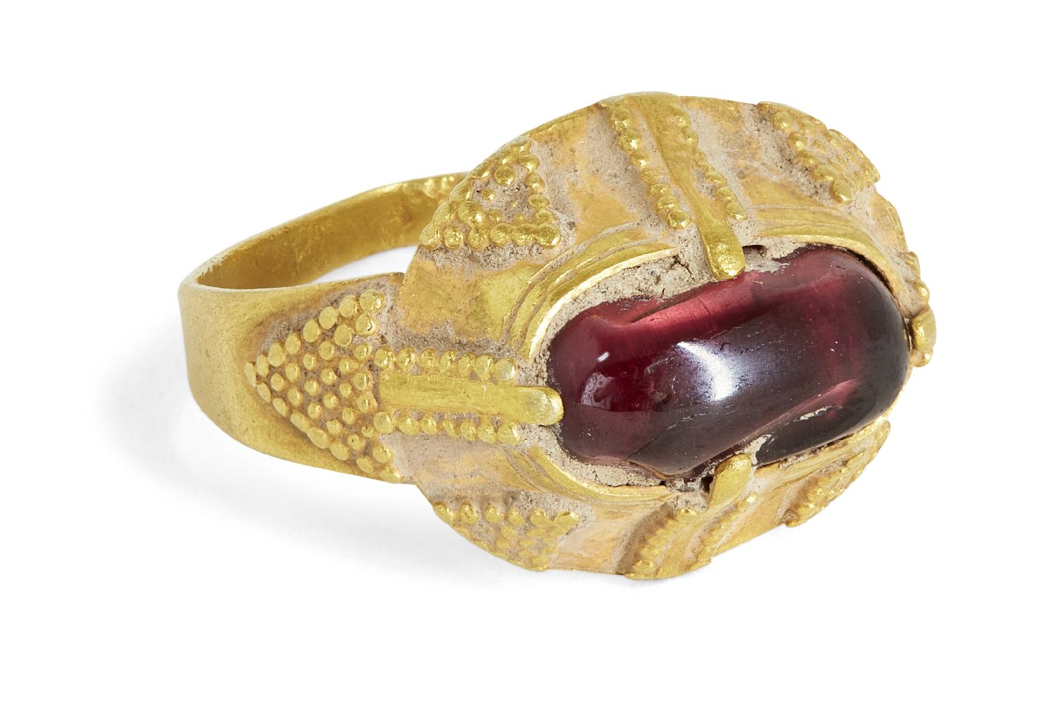 A garnet set gold ring, Iran, 12th-14th century, the oval bezel set with an uncut garnet in a claw