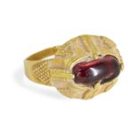 A garnet set gold ring, Iran, 12th-14th century, the oval bezel set with an uncut garnet in a claw