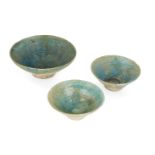 Three Kashan turquoise glazed bowls, Iran, 12th century, of conical form, with incised decoration,