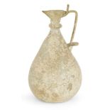 A pale green glass ewer, Persia, 10th century, the base flat with indented foot, globular body