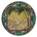 A Japanese Kutani dish, 19th century, painted with a tiger prowling amidst bamboo, signed fuku to