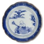 A Japanese porcelain blue and white dish, 18th/early 19th century, painted to the central reserve